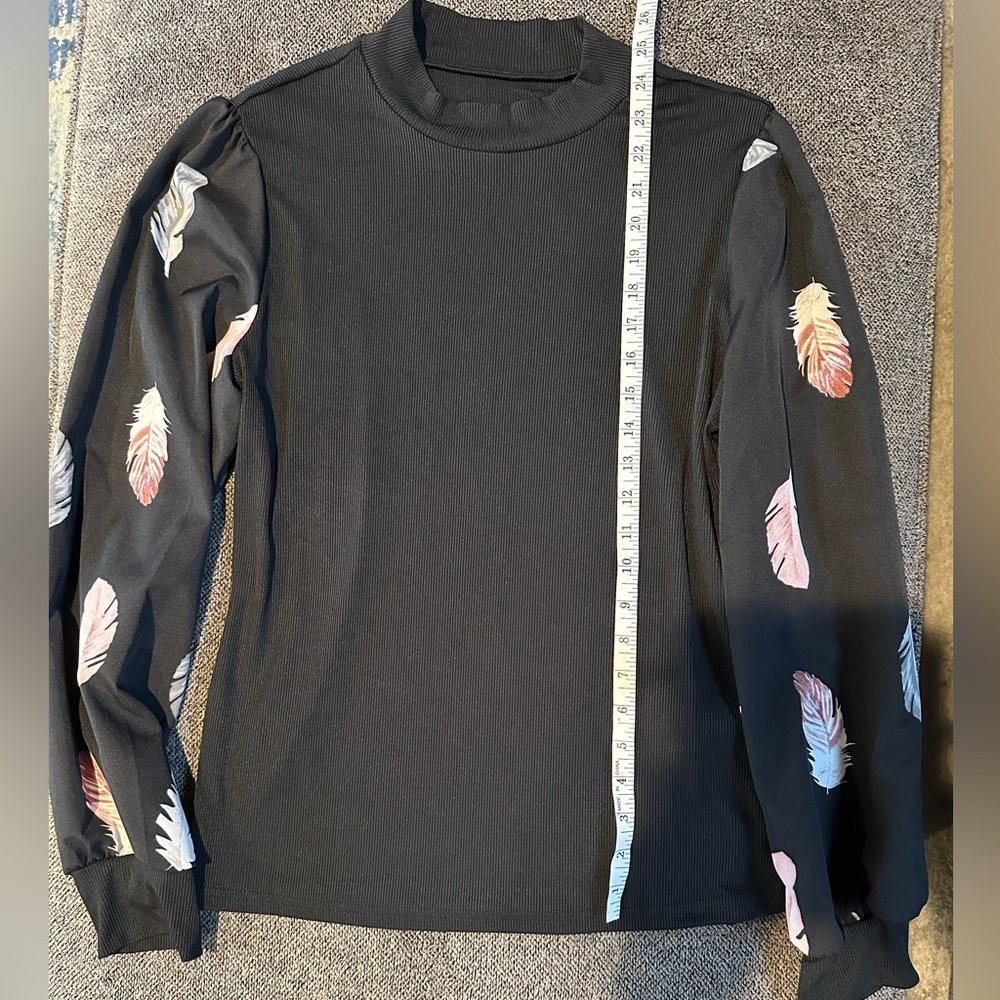 Never been worn long sleeve black top with feathers size 12